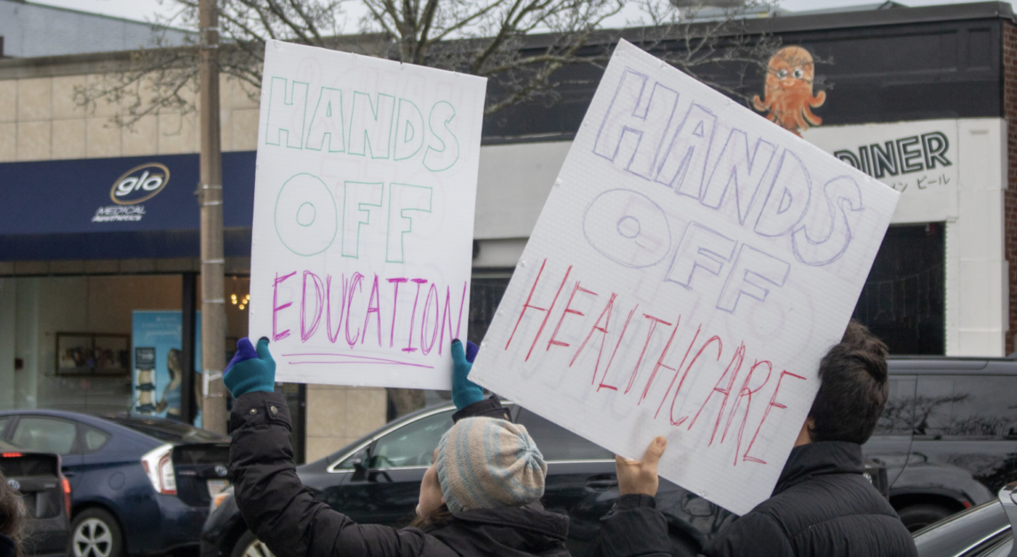 Needham resident Dan Schwartz held a “Stop the Steal” sign high, standing on the tip of the curb. (Sarah Fleming / Heights Editor)